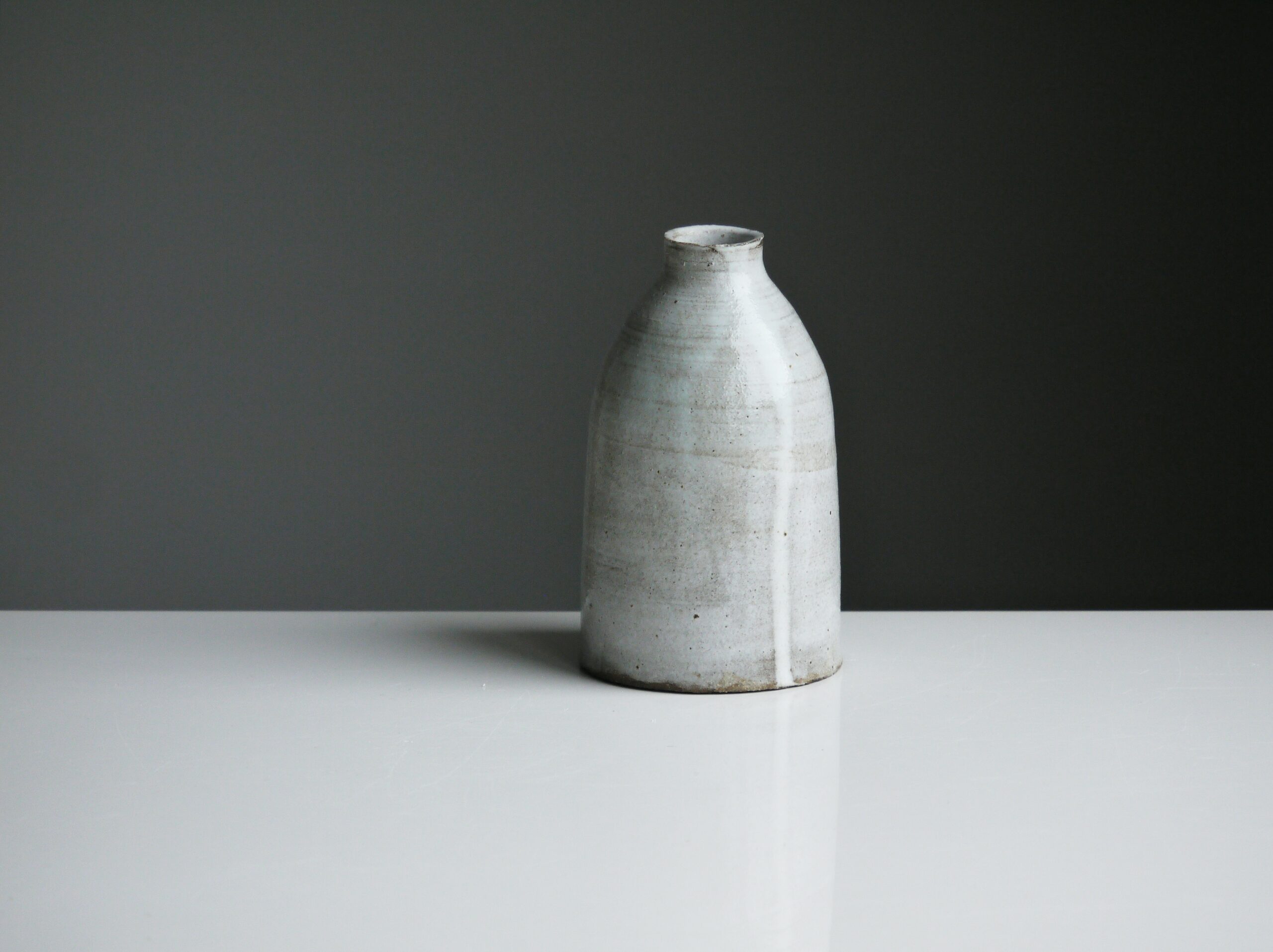 Stock photograph by Tom Crew of a piece of pottery on a light grey table, with a darker grey background behind.