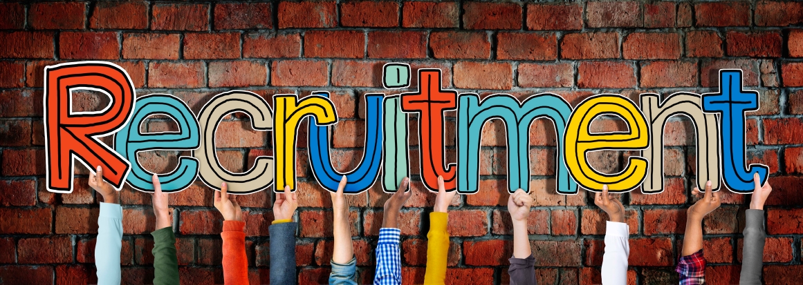 people's hands holding up letters that spell "Recruitment".